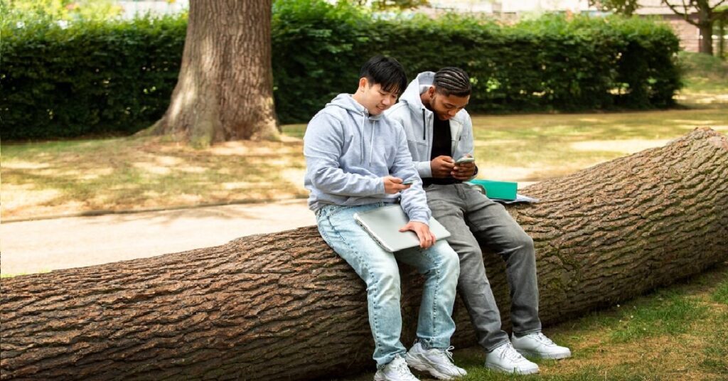 outdoor date ideas, outdoor date idea, couple strolling, couple sitting on a log, gay couple date, gay couple outdoor date
